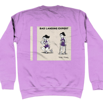 Purple Netball Jumper with Funny Bad Landing Expert Cartoon Print